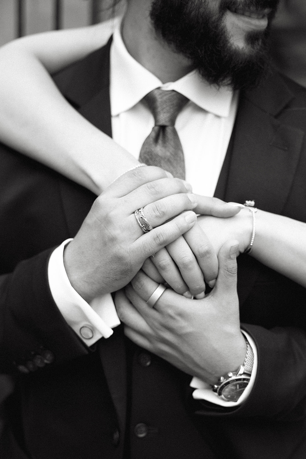 Black and white photo of a couple's hands at their wedding ceremony at Parkwood estates in Oshawa as officiated by Jennifer van Son from Gathered Ceremonies
